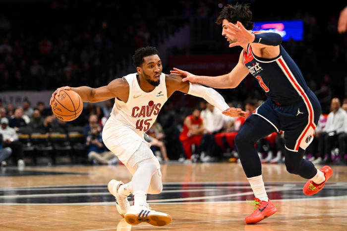 Feb 7, 2024; Washington, District of Columbia, USA; Cleveland Cavaliers guard Donovan Mitchell (45) dribbles as Washington Wizards forward Deni Avdija (8) defends during the first half at Capital One Arena.